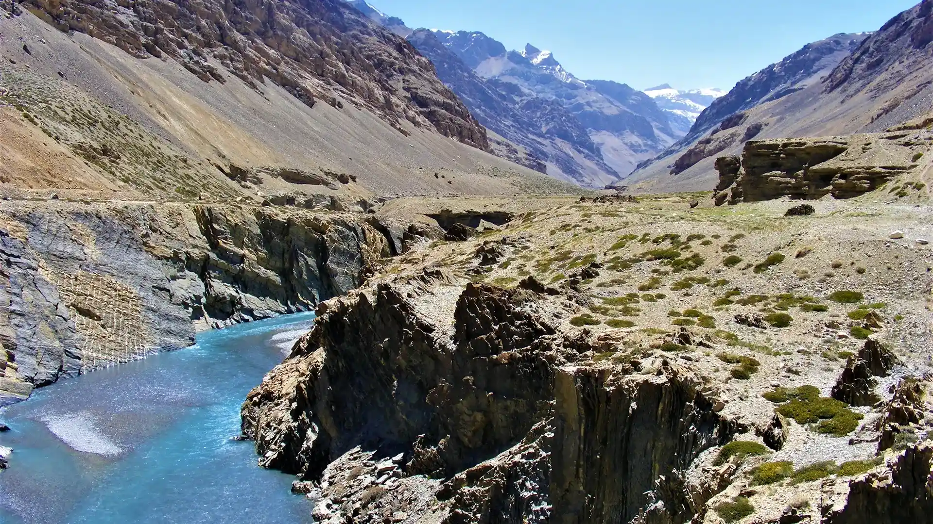 Rivière turquoise serpentant au fond d’une gorge de roche sombre sur la route de Leh à Manali, dans l’Himalaya indien
